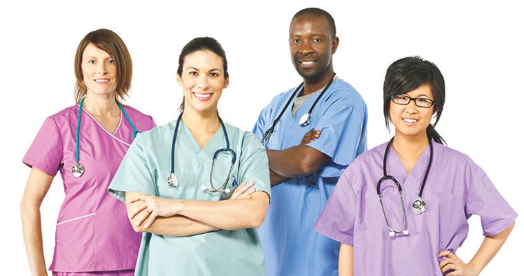 Four doctors wearing pastel scrubs