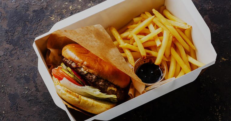Burger and fries in takeout box