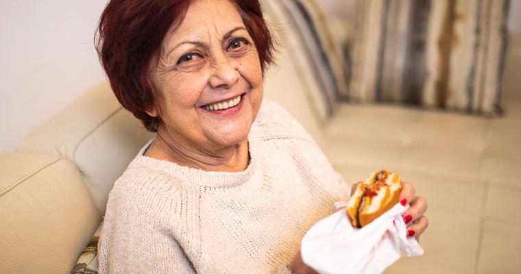 A woman enjoys a plant-based burger
