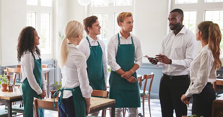 A restaurant manager speaks to a team of prospective employees