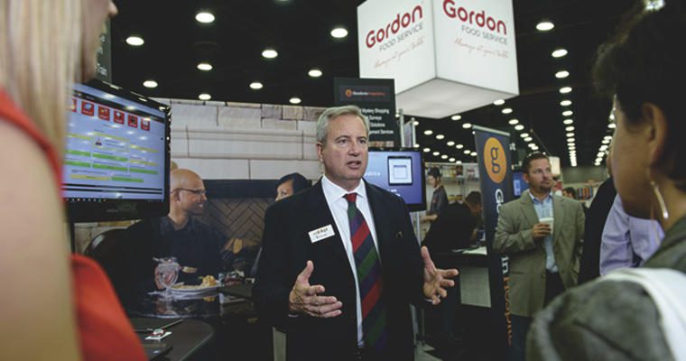 Gordon Food Service Sales Representative talking to customers on the show floor