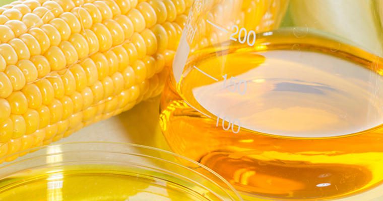 Corn with glass of syrup
