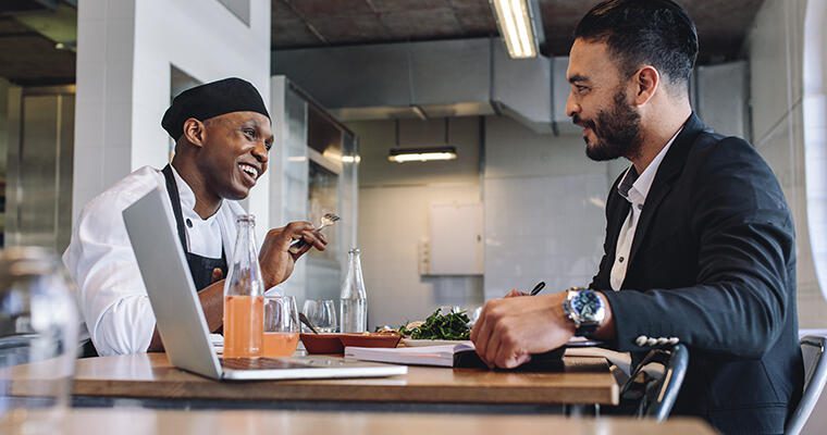 A restaurant owner mentors one of his employees.