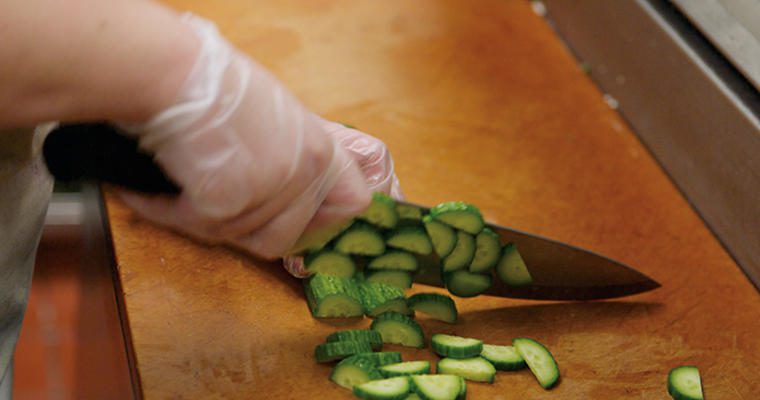 Chopping cucumbers with knife
