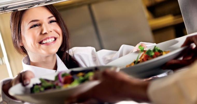 Server happily taking food tray