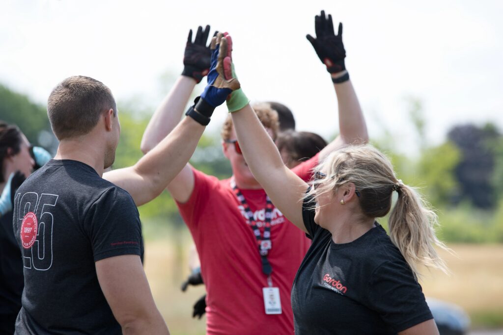 A team of Gordon Food Service employees high-fiving