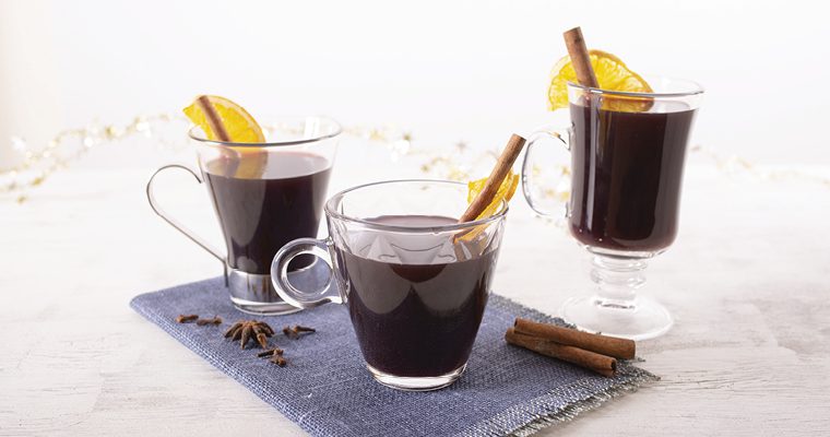Mulled wine with cinnamon sticks in coffee glasses