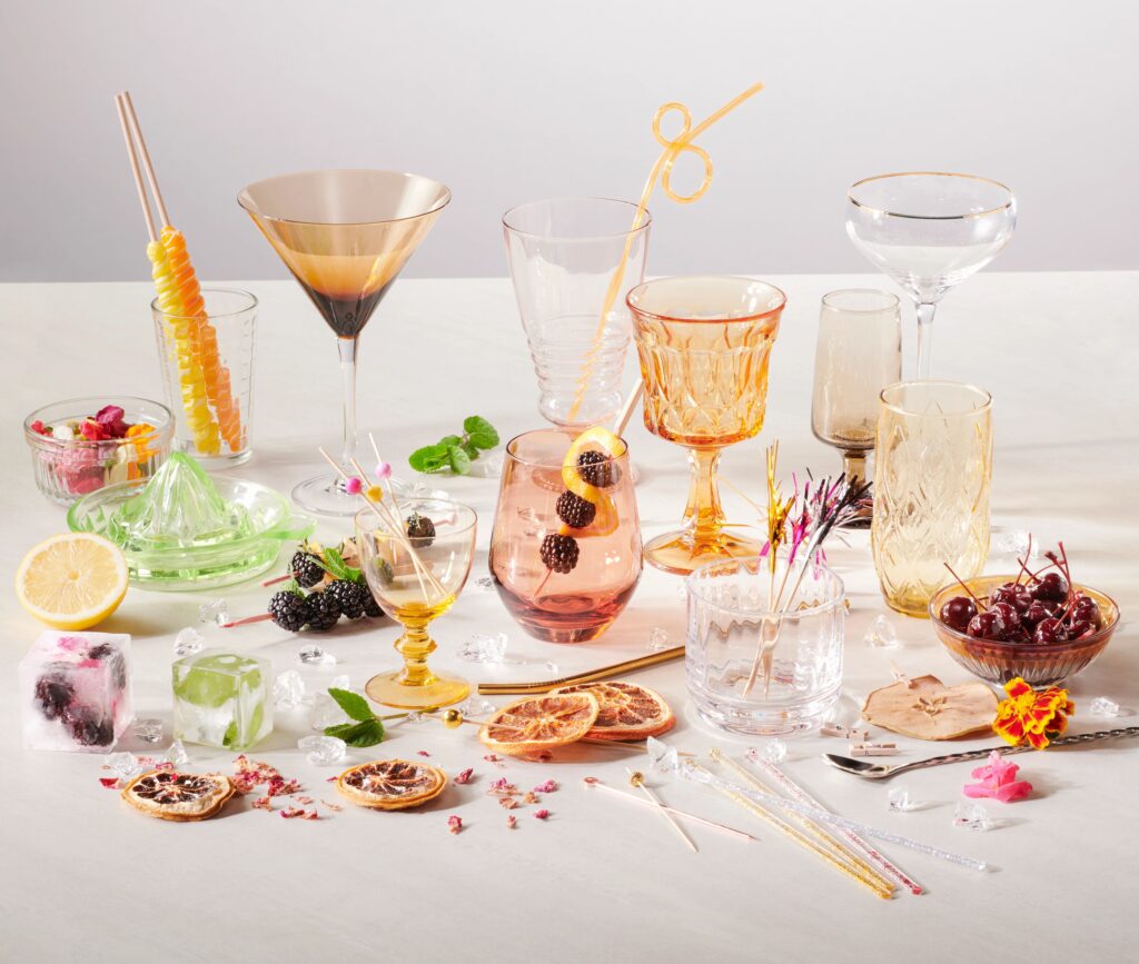 A variety of different colored cocktail classes with an assortment of garnishes