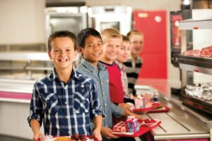 group of male students in line for lunch in the school cafeteria