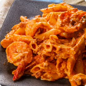 Cajun shrimp pasta in a white bowl.