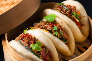 Birria bao in a steamer basket.