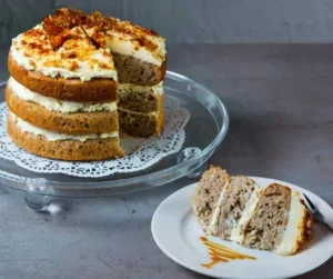 hummingbird cake sliced and served on a white plate.