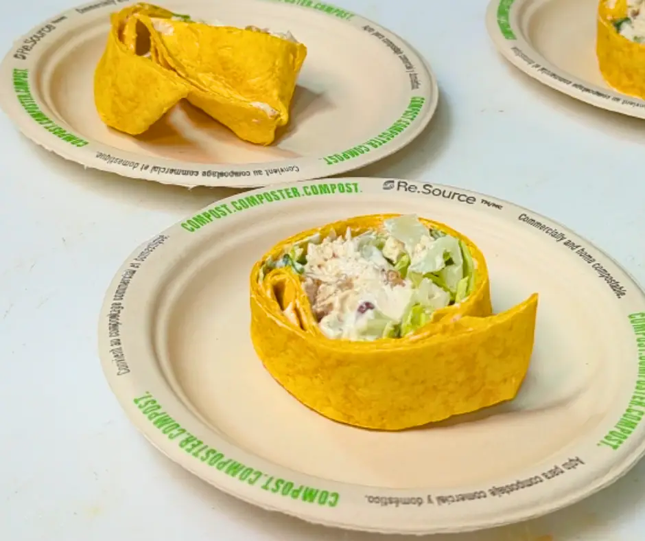 peach chicken salad wraps on compostable plates